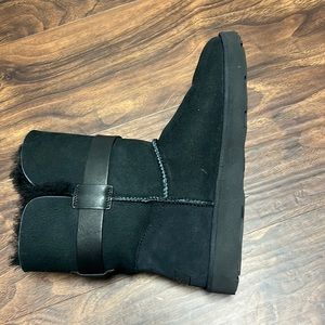 Woman’s black Ugg boots with a silver buckle